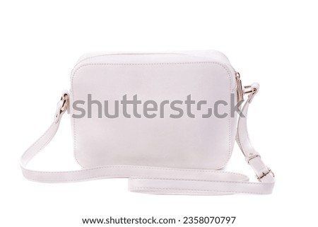White leather female bag with shoulder strap and zipper decorated with gold metal  isolated on a white background. Stylish accessories concept. Mock-up for advertising poster. Blogger content