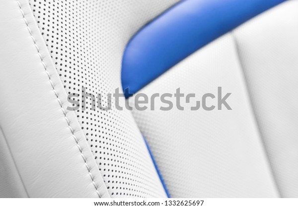 White\
leather interior of the luxury modern car. Perforated white leather\
comfortable seats with stitching. Modern car interior details. Car\
detailing. Car inside. Leather texture\
background