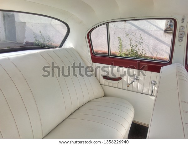 white leather interior of\
an old car