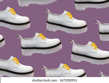 White Leather Platform Shoes Isolated On Purple Background. Classic Shoes On A High Black Tractor Platform. Fashionable Strict Low-heeled Shoes. Loafers With Lacing. Composition Of Clothes. Pattern