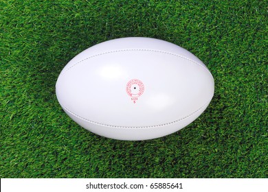 A White Leather Rugby Ball On Grass.