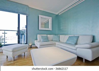 White Leather Sofa In A Light Blue Living Room