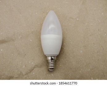 White Led Candle Shaped Lamp On Craft Paper.
