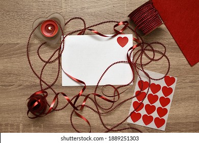 White letter, candle, ribbon and heart shaped candies. Gift for lovers