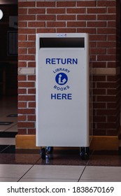 A White Library Book Return Bin With The Words 