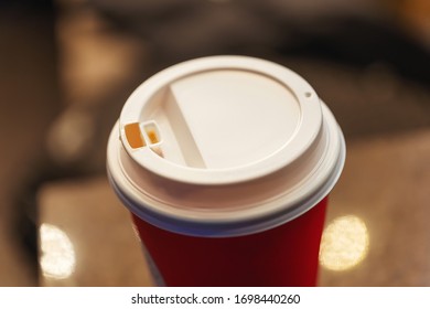 White Lid On A Red Plastic Cup Of Coffee Close-up. Cup For Drinks To Take Away.