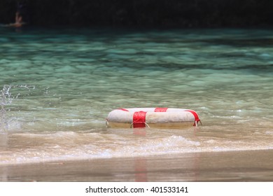 White Life Buoy In The Water, A Life Buoy In The Sea