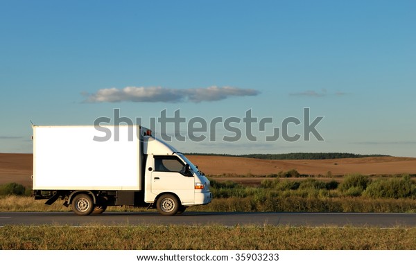 White Light-duty truck on highway over\
blue sky. See my portfolio for trucks and\
lorries