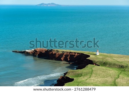 White Lighthouse on Red Cliffs Overlooking the Ocean, Magdalen Islands, Quebec