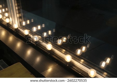 white lights out of focus with a reflection in the glass. Neon Lights.
