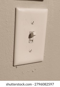 a white lightswitch on a white wall