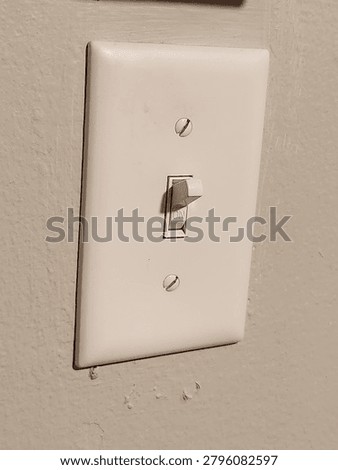 a white lightswitch on a white wall