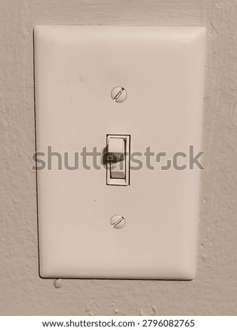 a white lightswitch on a white wall 