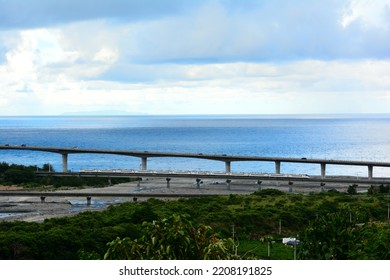 A White Limited Express Train Passes A Railway Bridge By The Sea.