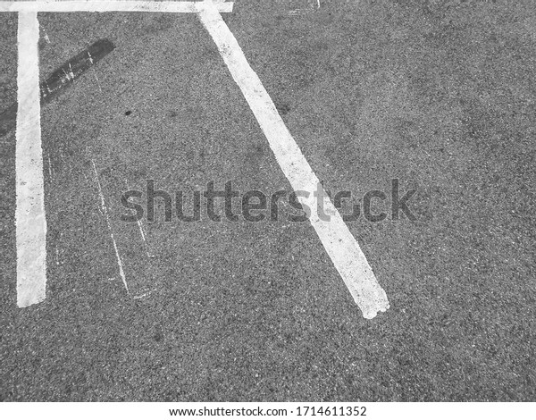 The white line divides the motorcycle parking space\
on the road