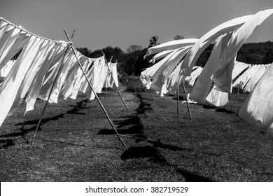 white linen drying on a clothesline in the field