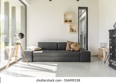 White living room with black furniture and window