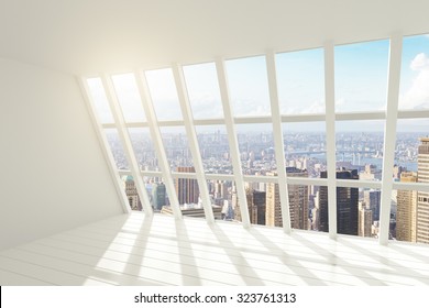 White loft interior with sunlight and city view
