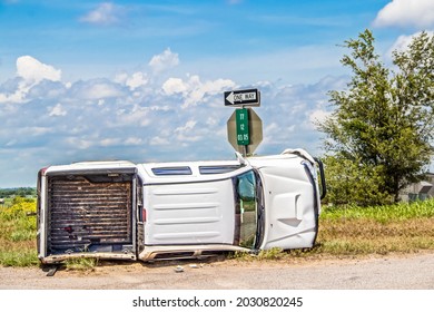 White Long Cab Pick Up Truck Turned On Its Side In A Wreck At An Intersection In The Country Beside A Stop Sign