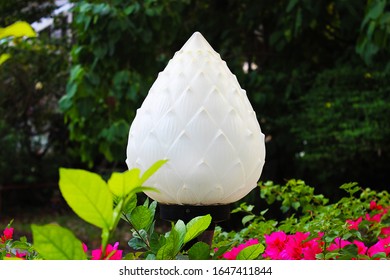 White lotus bud shape lamp on a Thai temple wall in Bangkok, Thailand