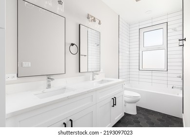A White Luxury Bathroom With A White Vanity Cabinet And Marble Countertop, Subway Tile Shower, And Dark Hexagon Tiled Flooring.