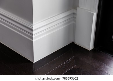 White Luxury Moulding Floor With Dark Wooden Floor Interior Detain Concept