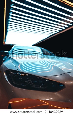 white luxury sport car at showroom, futuristic vehicle front view, aggressive and elegant headlamp of futuristic sportcar