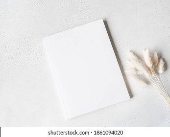 White Magazine Cover Mockup And White Lagurus On Light Grey Background. Top View. Copy Space