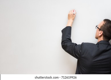 White male draws on empty or blank whiteboard