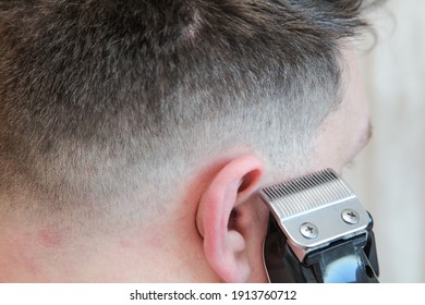 A white male during a fresh shaved hair cut with electric clippers and foils at home in the bathroom.  - Shutterstock ID 1913760712