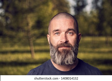 A White Man About 43 Years Old With Short Hair And Beard Has A Rest In A Park, Close-up.