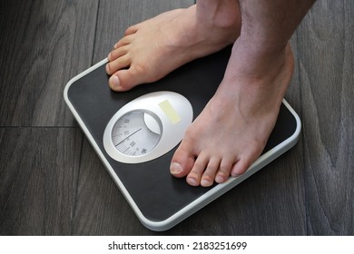 White Man Feet On Bathroom Scale , Weight Check