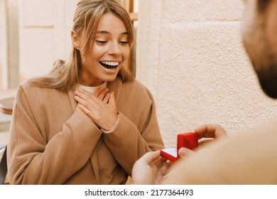 White Man Making Proposal To His Girlfriend With Engagement Ring Outdoors
