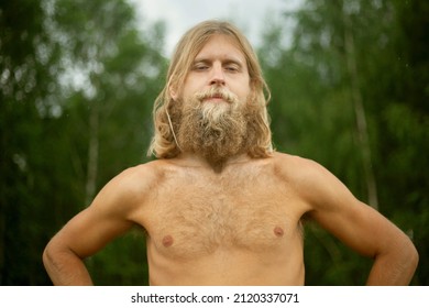 White Man Naked From Waist Up. Guy In Nature In Woods. Blonde With Thick Beard And Long Hair. Traveler In Wilderness.