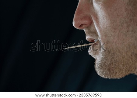white man with a toothpick in his mouth close up on the face abstract perspective