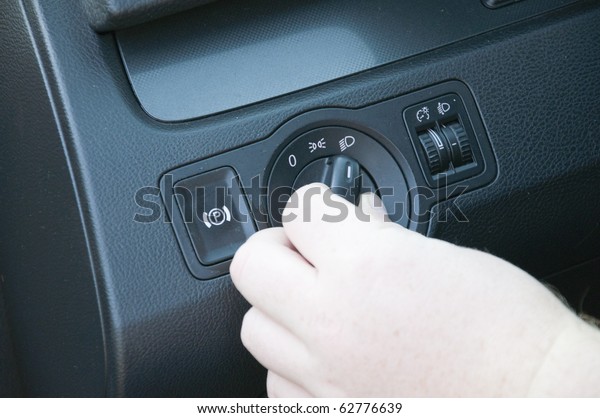 white man turn on the\
lights in car