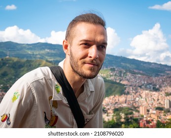 White Man without Mask is Posing with the Background of the City of Medellin, Colombia - Powered by Shutterstock