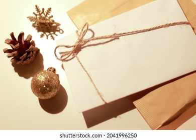 White Manila Envelope With Christmas Ornaments Around It