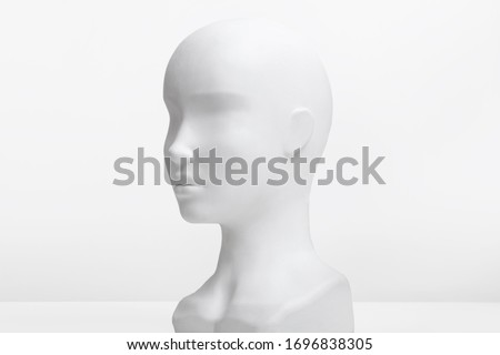 White mannequin head on a white background