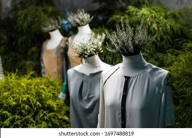 White mannequins , with heather on a dark green forest background. The concept of fashion, style, beauty, ecology, recycle, sustainability, reusing, concept. Zero and fabric waste, creative background