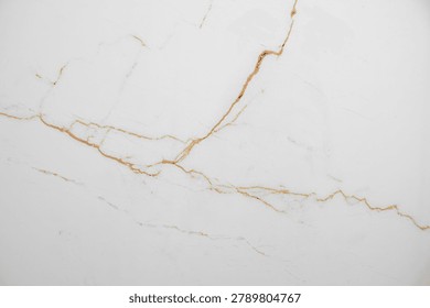 A white marble background with subtle brown veining and a natural stone texture. Concept for a luxury and elegant surface for a banner or advertising display. Top view, copy space.