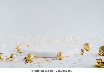 White marble cosmetic podium product and Christmas golden decoration. Product presentation scene for cosmetic or beauty product presentation on white background. Front view. Copy space