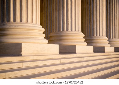 White Marble Neoclassical Columns Of The Portico Of The Supreme Court Of The United States Building In Soft Sunset Light In Washington DC, USA