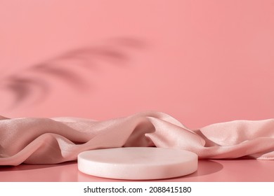 White marble podium on the pink background with silk fabric and shadow of tropical plant. Podium for product, cosmetic presentation. Creative mock up. Pedestal or platform for beauty products. - Shutterstock ID 2088415180