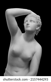 White marble sculpture head of young woman. Statue of sensual renaissance art era naked woman in circlet antique style isolated on black background