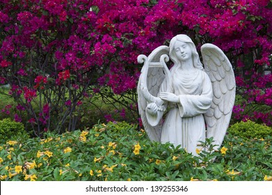 White Marble Statue Of Angel In Garden