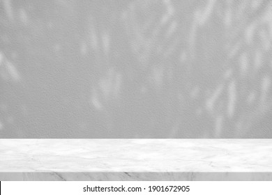 White Marble Table With Leaves Shadow In The Park On Concrete Wall Texture Background, Suitable For Product Presentation Backdrop, Display, And Mock Up.