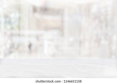 White Marble Table Top On Blur Coffee Shop Window Background. For Product Or Foods Montage.