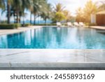 white marble top with blurred empty Swimming pool background can be used for mocking up or display product to make advertising. 