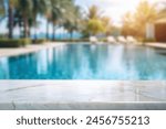 white marble top with blurred empty Swimming pool background can be used for mocking up or display product to make advertising.